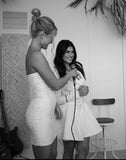 blonde model wearing I Am Woman Mini dress by Amy Taylor Collection giving speech. view from front side