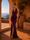 Woman in a purple dress standing in a sunlit room with a scenic view of the ocean.