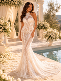 Woman in a sparkling wedding dress standing by a pool with floral decorations.